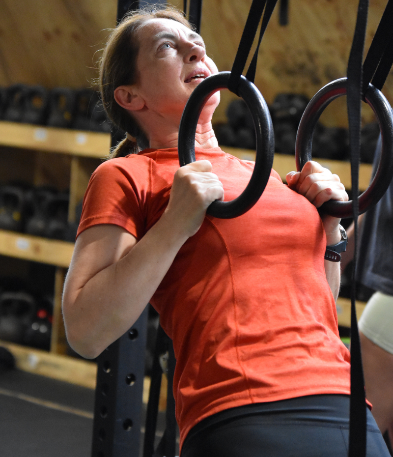 Zest Women at The Fitness Studio- mid life woman pulling body weight on rings